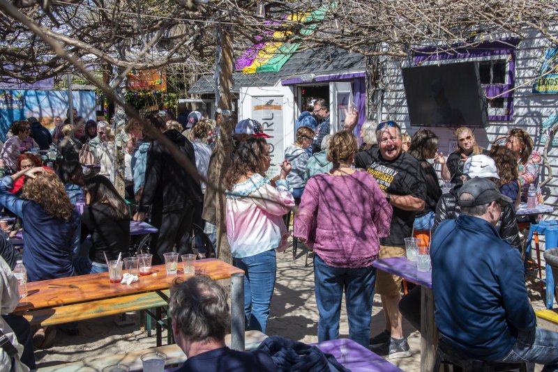 Guests enjoy the beautiful weather on the Purple Parrot patio.